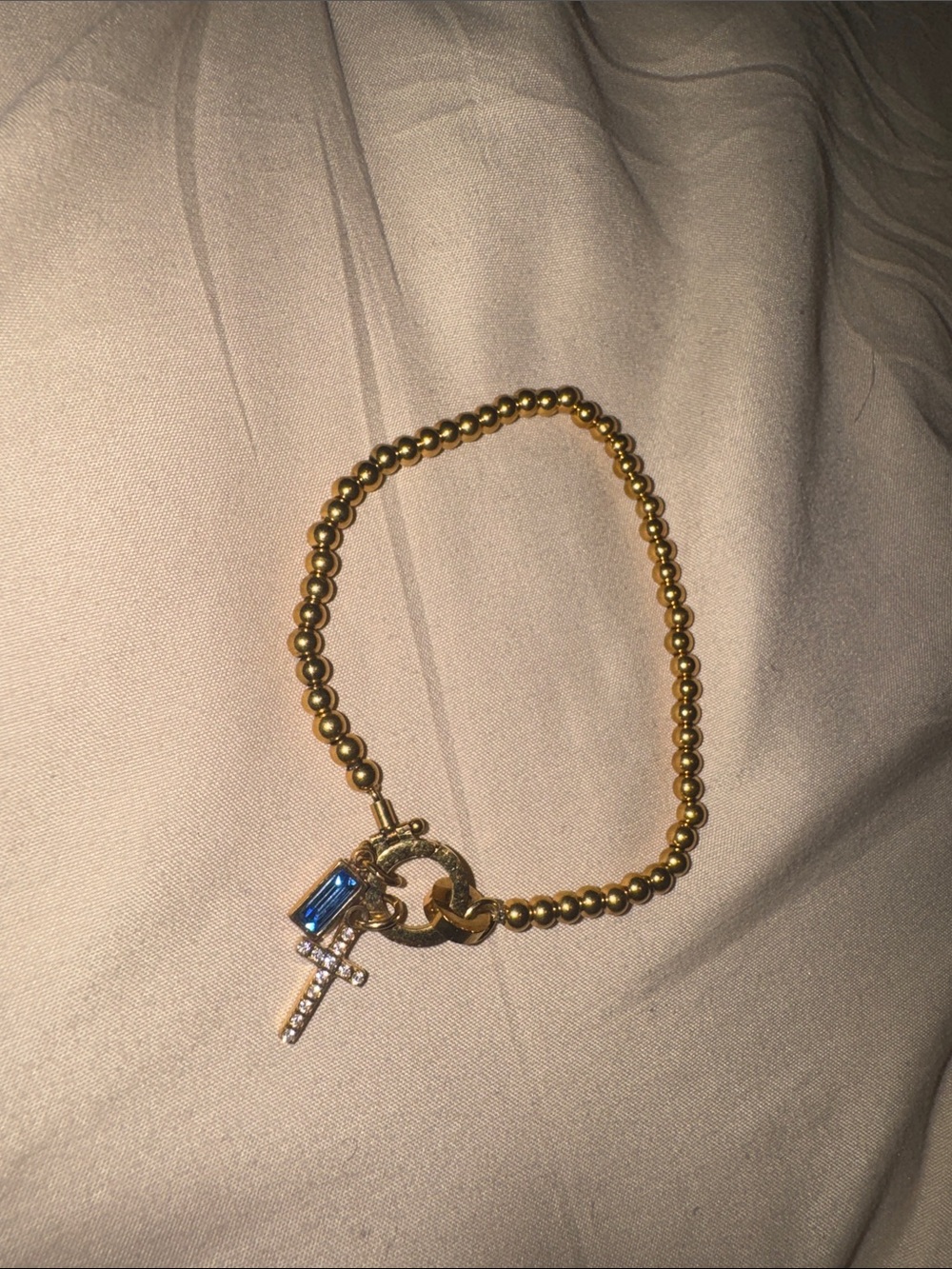 Gold Beaded Bracelet with Blue Crystal and Cross Charm